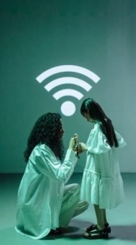 A woman and child pose in front of a Wi-Fi symbol, highlighting TV and internet services available in Tacoma, WA.
